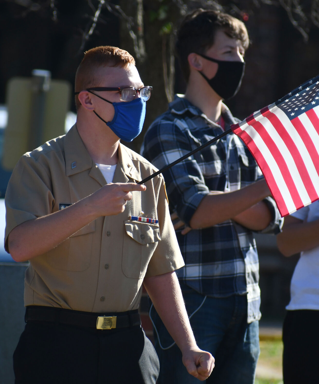 Anthony Reisinger and Jacob Trentmann wave flags